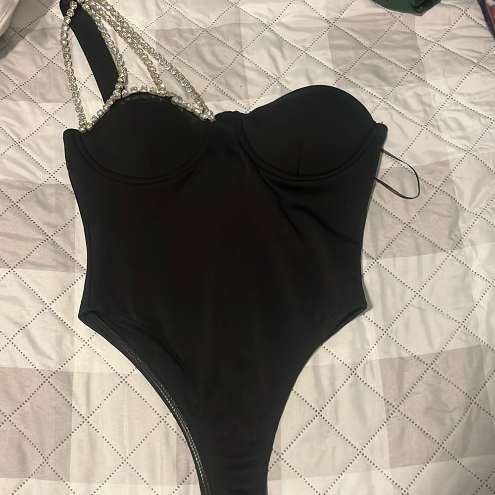 Black body suit bedazzled one shoulder.
